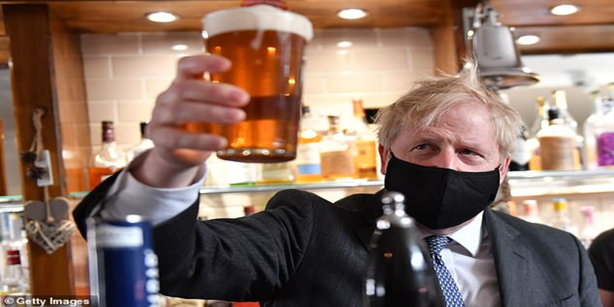 Boris Johnson enjoys his first pint after the shutdown