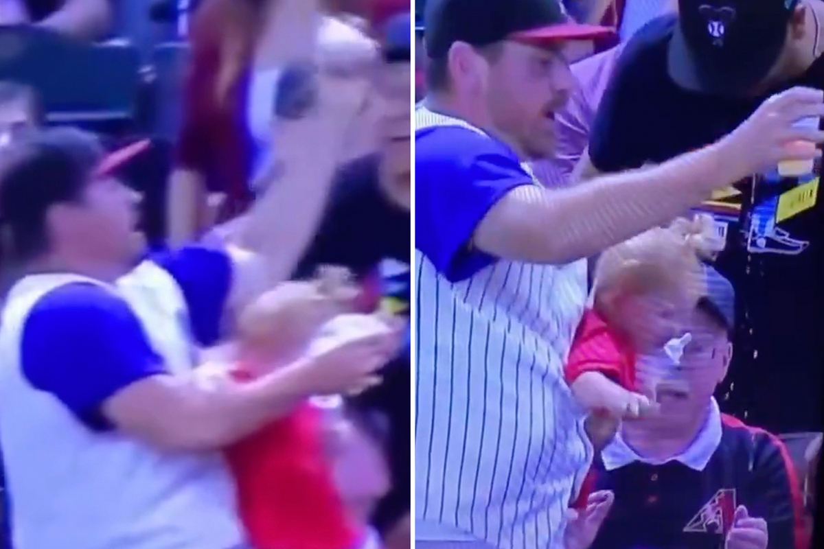 Dad almost drops his son while trying to catch a baseball