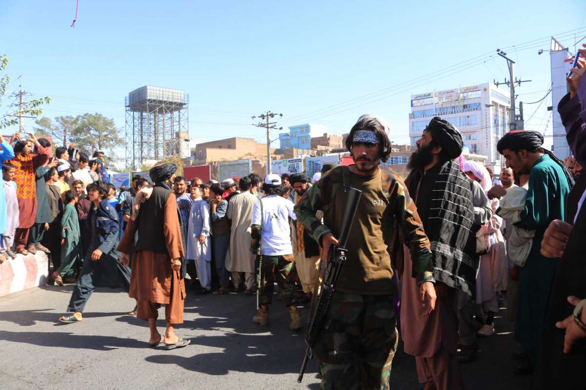 Taliban hang a corpse from a crane in the main square of the Afghan city