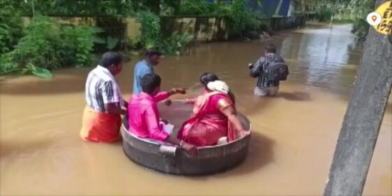 Desperate to get married, Indian couple floats in large pot to reach their wedding after flooding